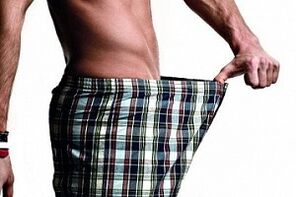 The man looks at the penis and wants to increase it